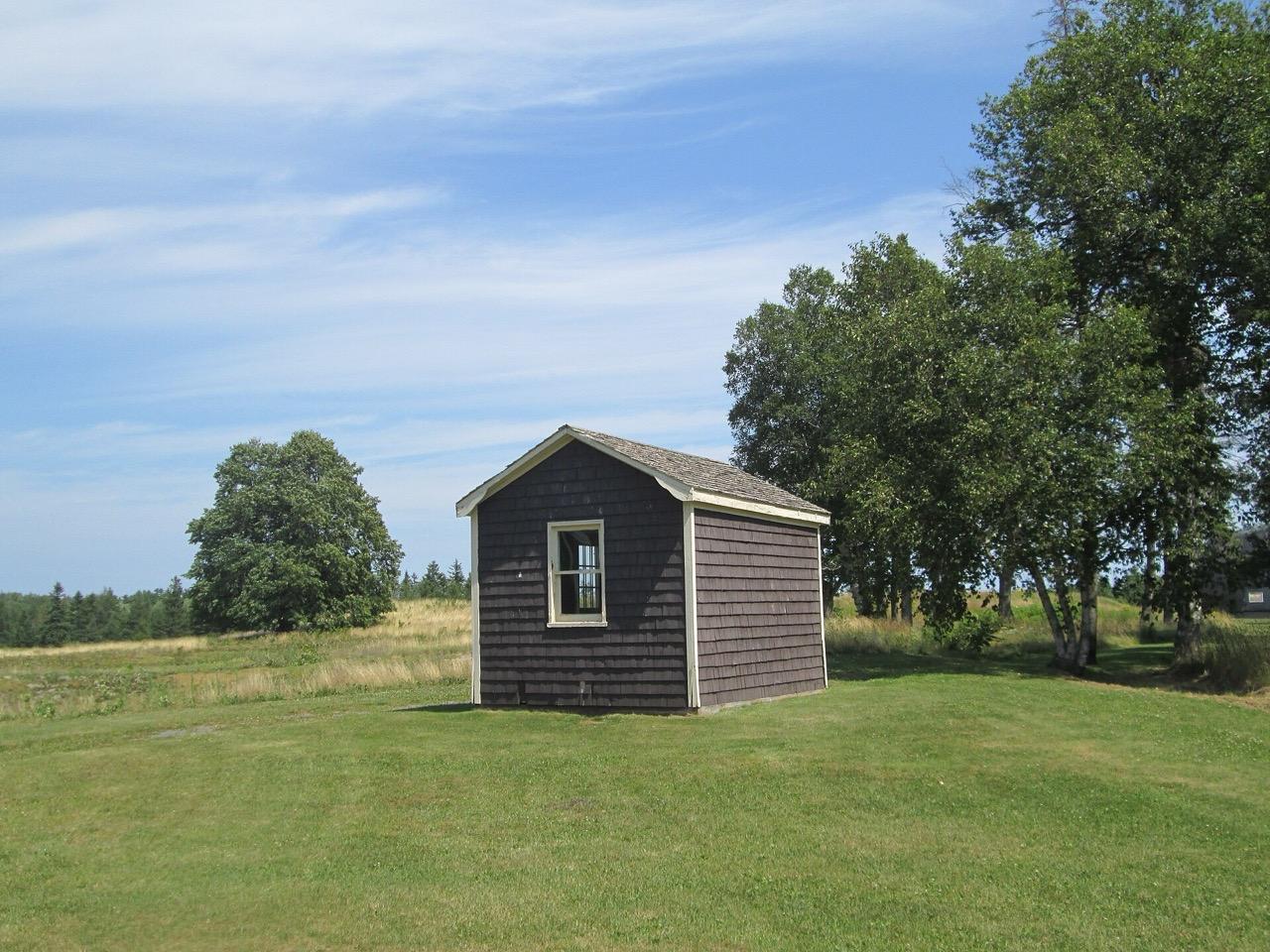 A small shingled building on the grounds of Brudenell River Provincial Park