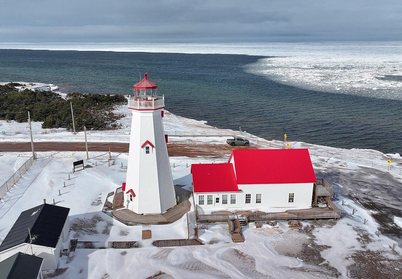 East Point Lighthouse at the eastern tip of Prince Edward Island, with ice along the shore in a colder season