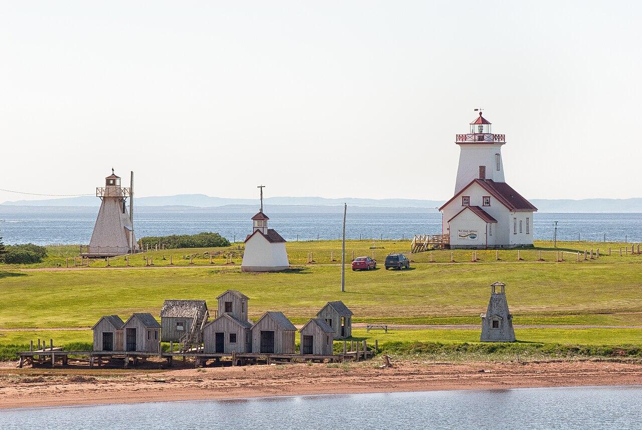 Wood Islands Lighthouse and a smaller range light above a red sand shore